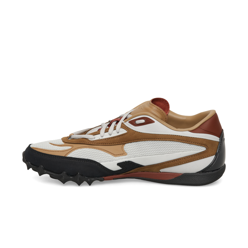 White and brown Reebok Spike Racer low-top sneaker with a black, spiked rubber outsole.
