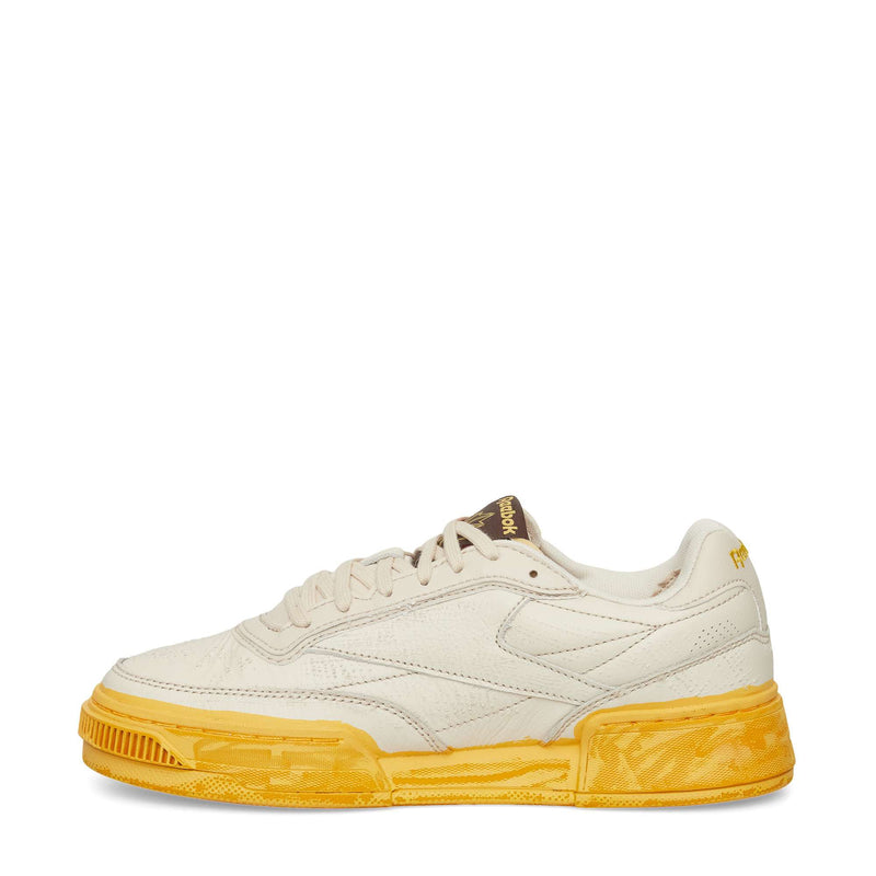 The Reebok Club C LTD Shoes feature a cream upper, textured yellow sole, low-top silhouette, and subtle side and tongue branding—an iconic lifestyle classic shown against a white background.