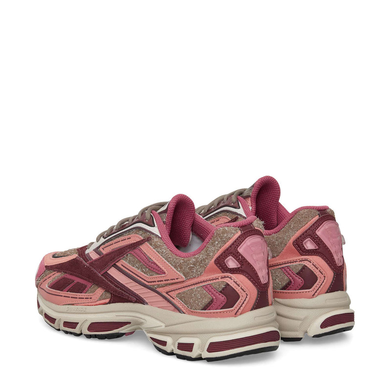 A pair of Reebok Premier Road Ultra Shoes in pink and maroon with textured suede and mesh, white soles, dual-density midsole, and maroon accents, viewed from a rear side angle on a white background.