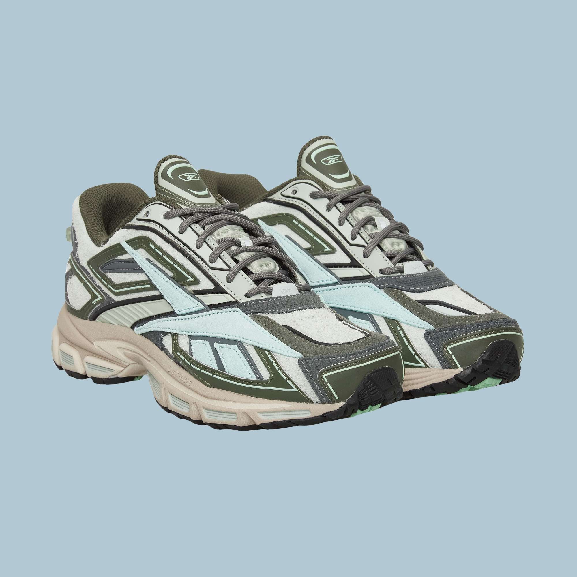 Reebok Premier Road Ultra Shoes with olive green, grey, white, and light blue panels and thick dual-density midsoles are shown against a plain light blue background.