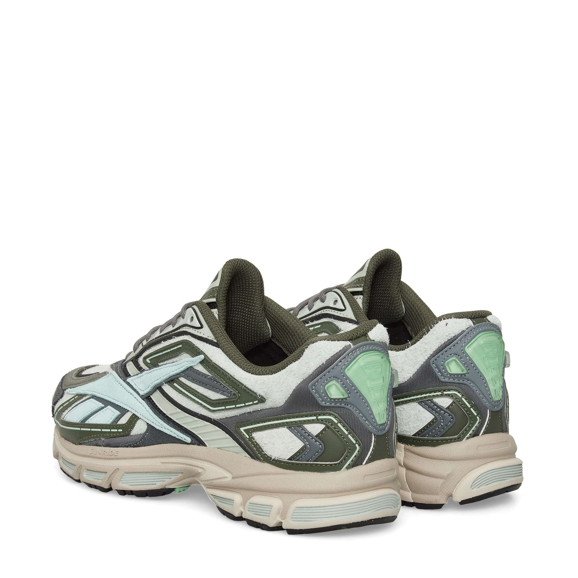 A pair of athletic sneakers in shades of green, gray, white, and mint, shown from the back and side, with chunky soles and layered material detailing.