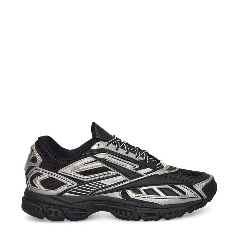 The Reebok Premier Road Ultra Shoes feature a black mesh upper with metallic silver accents, black laces, angular patterns, a chunky dual-density rubber sole, and boast a modern, sporty look.