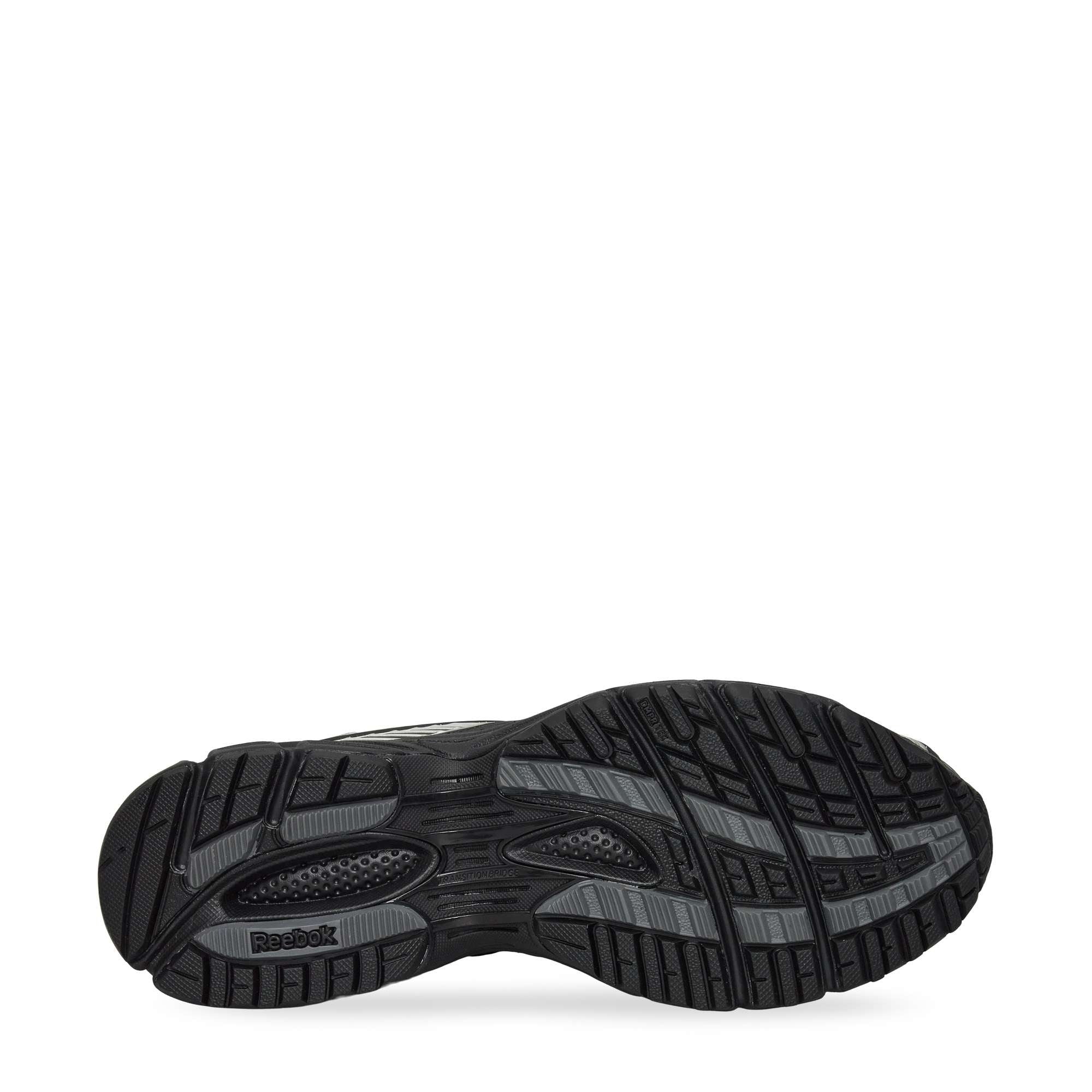The image displays the black rubber sole of the Reebok Premier Road Ultra Shoes, featuring a textured tread for grip and the Reebok logo by the heel. The background is plain white.