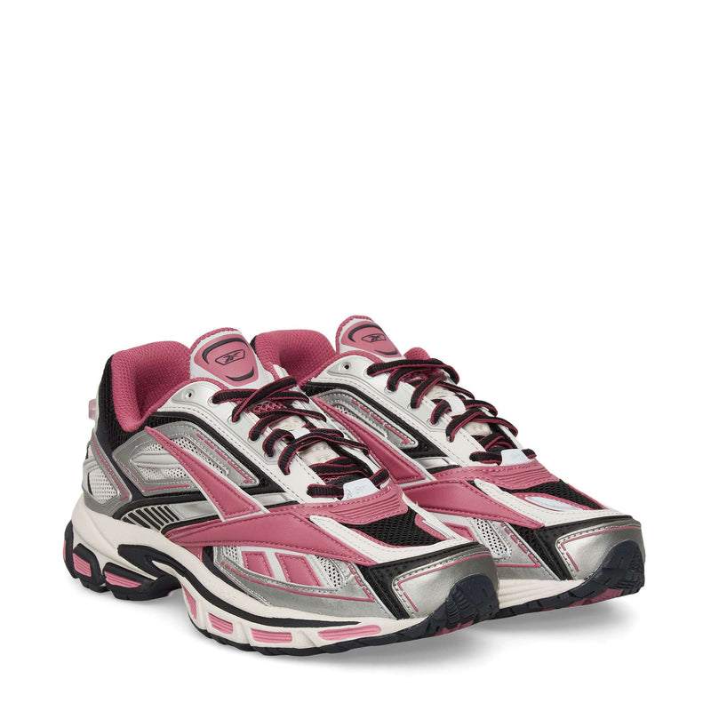 The Reebok Premier Road Ultra Shoes are athletic sneakers in pink, silver, black, and white, featuring mesh and synthetic panels, lace-up fronts, a dual-density midsole, and thick textured soles inspired by classic running style.