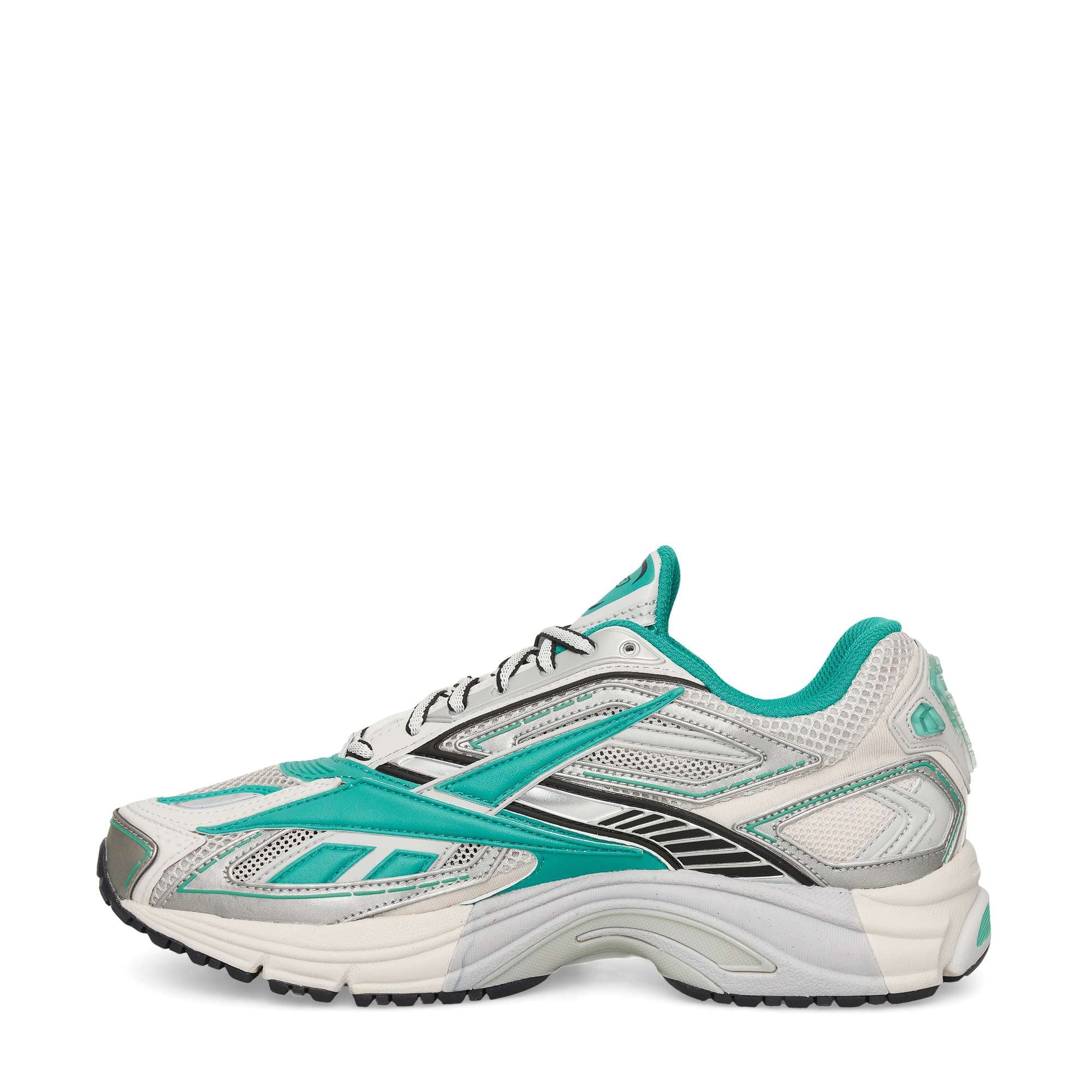 A gray and teal athletic sneaker with black and white accents, featuring a mesh upper, lace-up front, and thick, cushioned sole, viewed from the side against a white background.