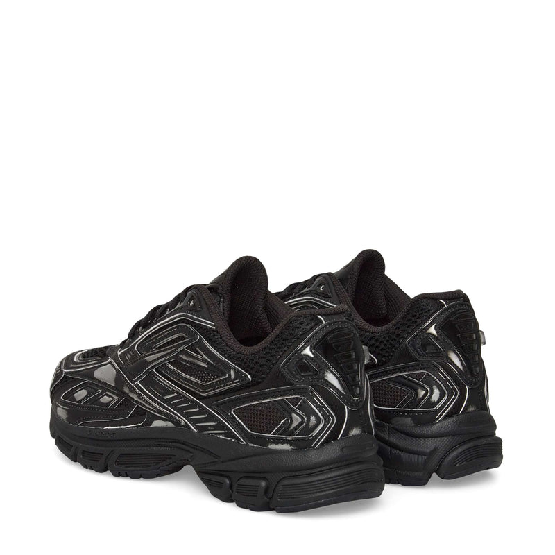The Reebok Premier Road Ultra Shoes in black with silver accents are shown from the back and slightly to the side, featuring thick soles, breathable mesh panels, and a supportive dual-density midsole.