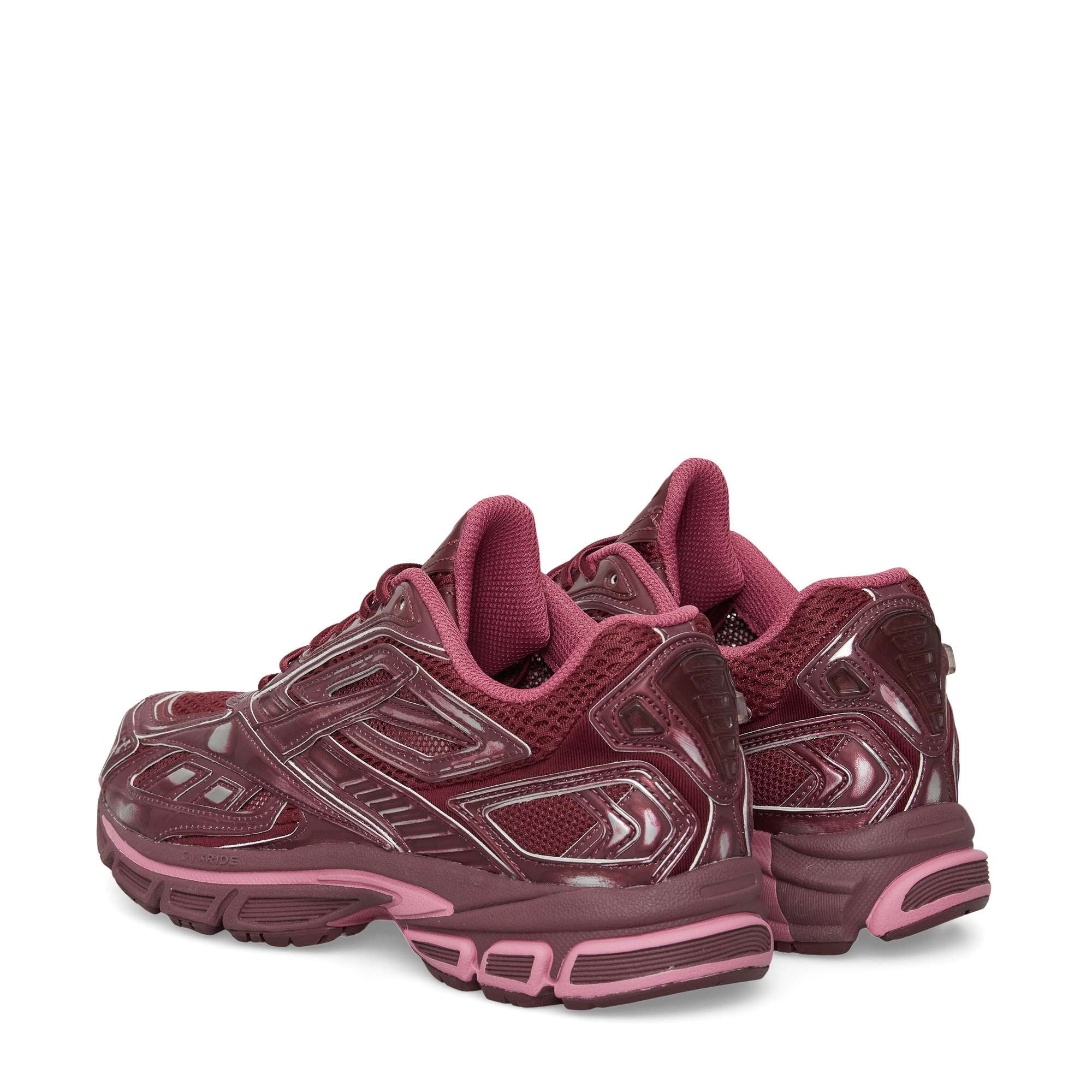 The Reebok Premier Road Ultra Shoes in maroon feature glossy details and pink accents, designed for comfort and stability, displayed from the back and side on a white background.