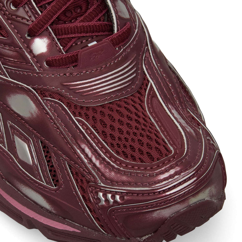 Close-up of the front of Reebok Premier Road Ultra Shoes, featuring maroon mesh and shiny synthetic overlays with detailed toe box stitching that emphasize comfort and stability.