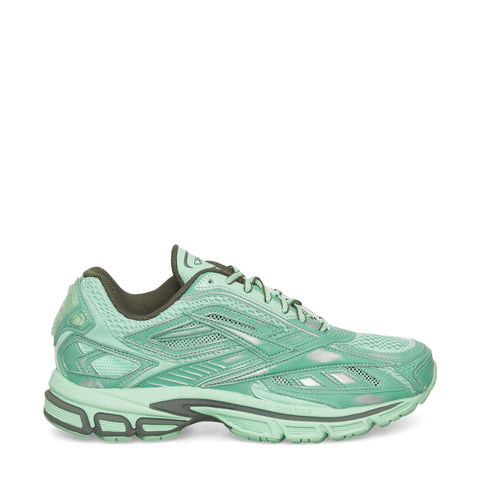 The Reebok Premier Road Ultra Shoes are mint green running sneakers with a mesh upper, textured overlays, dark green lining, and a chunky patterned sole with dual-density midsole, shown in side profile on a white background.
