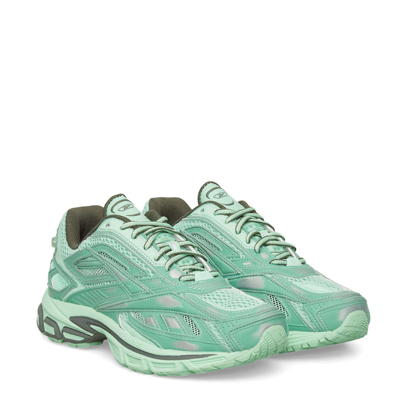 A pair of Reebok Premier Road Ultra Shoes in light mint green with mesh and synthetic overlays, gray accents, lace-up closures, and cushioned dual-density midsoles are displayed on a white background.