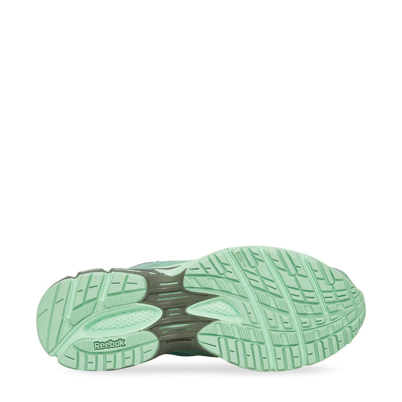 The image displays the sole of the Reebok Premier Road Ultra Shoes in mint green, highlighting textured grip patterns, a black arch support section, and visible details of its dual-density midsole for enhanced comfort.
