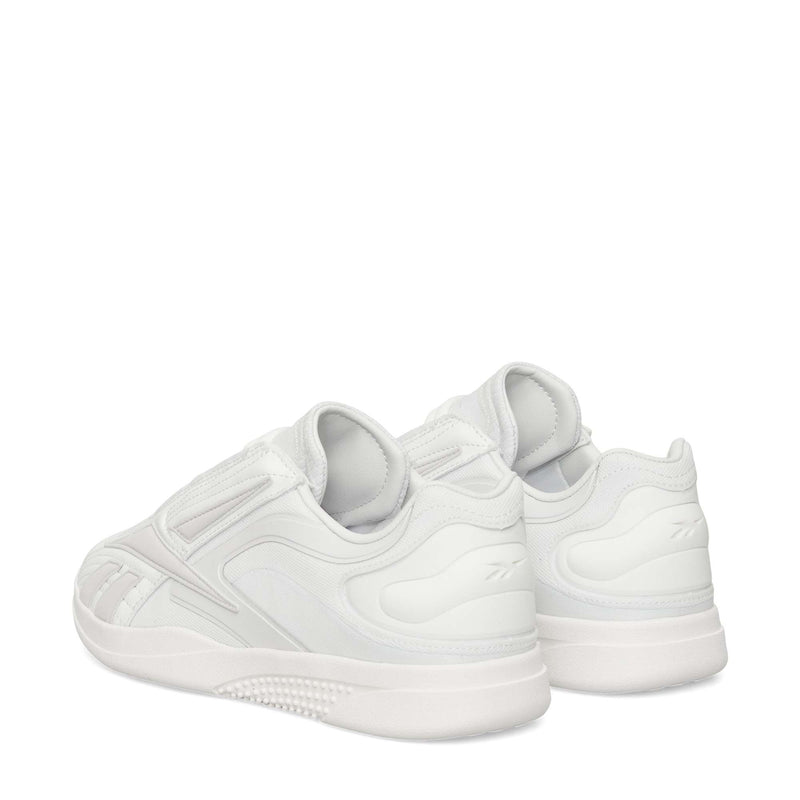 The Reebok Hammer Pro LTD Shoes are shown from the back and side, boasting a sleek minimal design, durable textured rubber soles, and subtle stitching details.