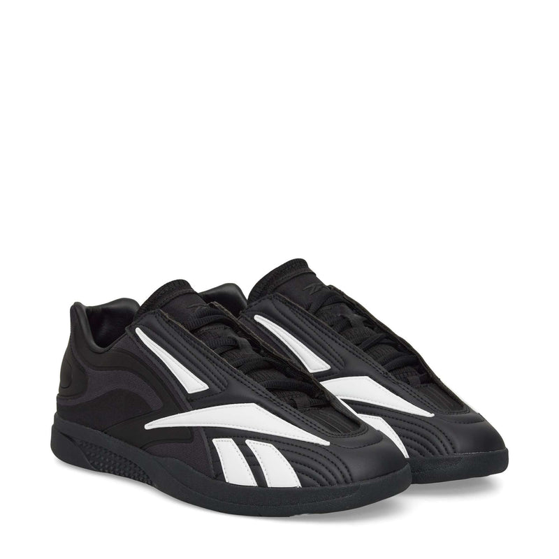 The Reebok Hammer Pro LTD Shoes are black faux leather sneakers with modern, graphic white stripes and a chunky, durable rubber sole, displayed on a white background.