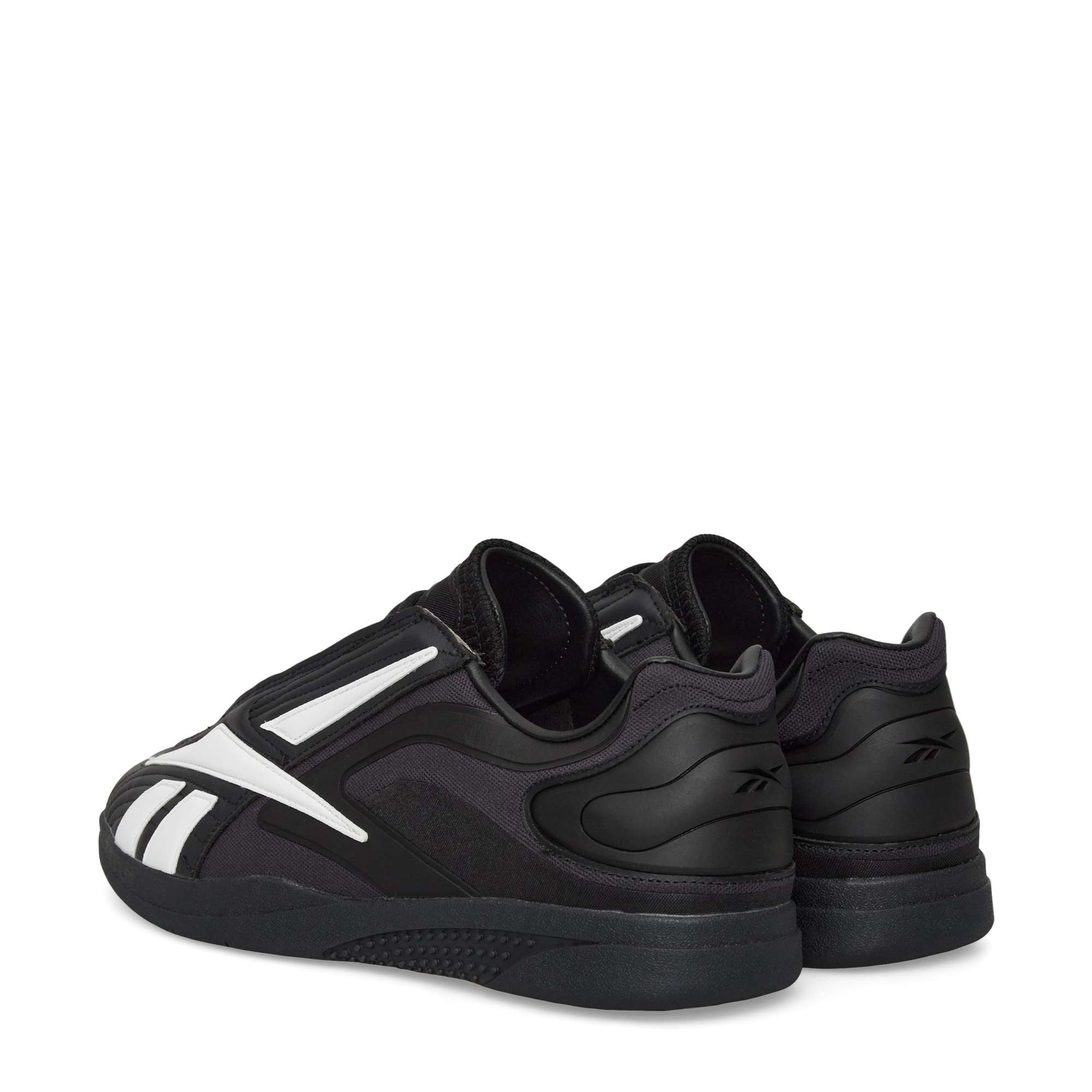 The Reebok Hammer Pro LTD Shoes feature a durable rubber sole, black faux leather upper, white accents, and the Reebok logo, shown from a rear side angle on a plain white background.