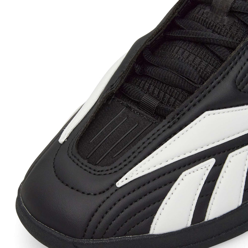 Close-up of Reebok Hammer Pro LTD Shoes in black with white accents, highlighting detailed stitching, laces, textured faux leather upper, and a durable rubber sole.
