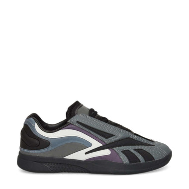 The Reebok Hammer Pro LTD Shoes feature layered faux leather panels in gray, black, and purple, a modern low-top design, black laces, and a chunky black sole—all set against a crisp white background.