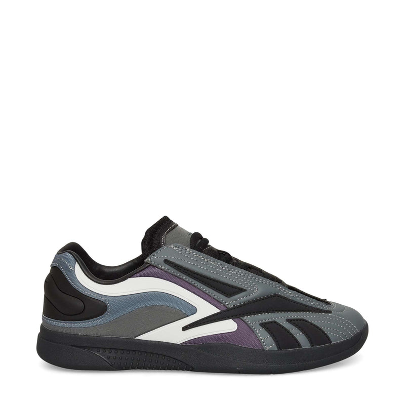 The Reebok Hammer Pro LTD Shoes feature layered faux leather panels in gray, black, and purple, a modern low-top design, black laces, and a chunky black sole—all set against a crisp white background.