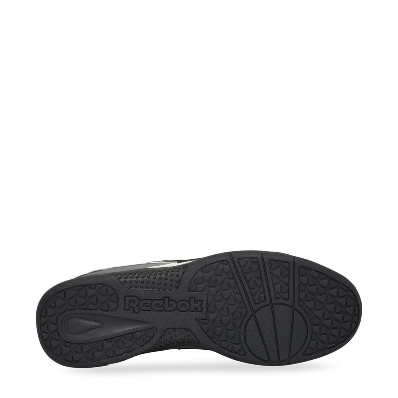 A bottom view of the Reebok Hammer Pro LTD Shoes shows a textured rubber sole with diverse patterns and a central Reebok logo, while the faux leather upper gives these sneakers a sleek, modern look.
