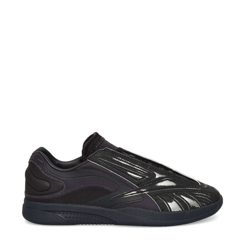 A black Reebok Hammer Pro LTD Shoe with a glossy, textured faux leather upper, mesh and synthetic overlays, and a durable rubber sole, shown in side profile on a white background.