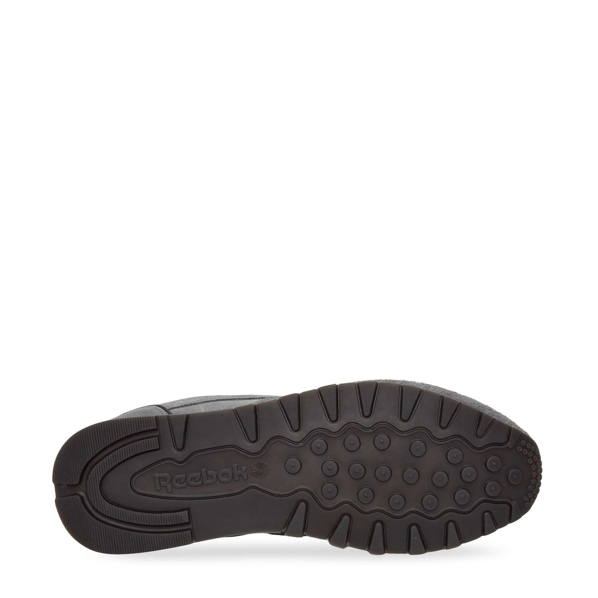 A black rubber sneaker sole with textured grip patterns and the Reebok logo embossed near the heel, shown against a white background.