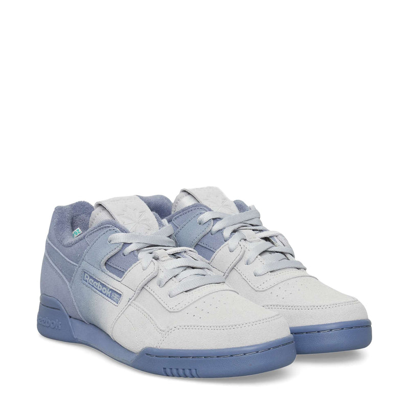 A pair of Reebok sneakers featuring a light gray upper with blue accents on the laces, tongue, and sole, shown at a slight angle on a white background.