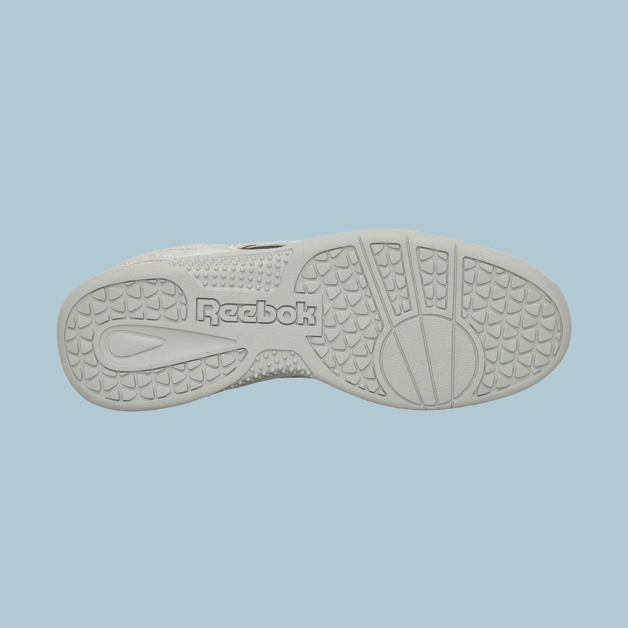 The image shows the white sole of Reebok Pleasures Hammer Street Shoes against a light blue background, featuring textured grip patterns and the embossed Reebok logo in the center.