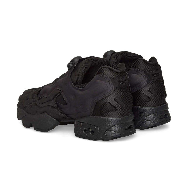 The Reebok Instapump Sliver sneakers in black feature a chunky sole, textured details, and a slip-on design without visible laces, offering enhanced comfort with Hexalite cushioning. Shown from the back and side.