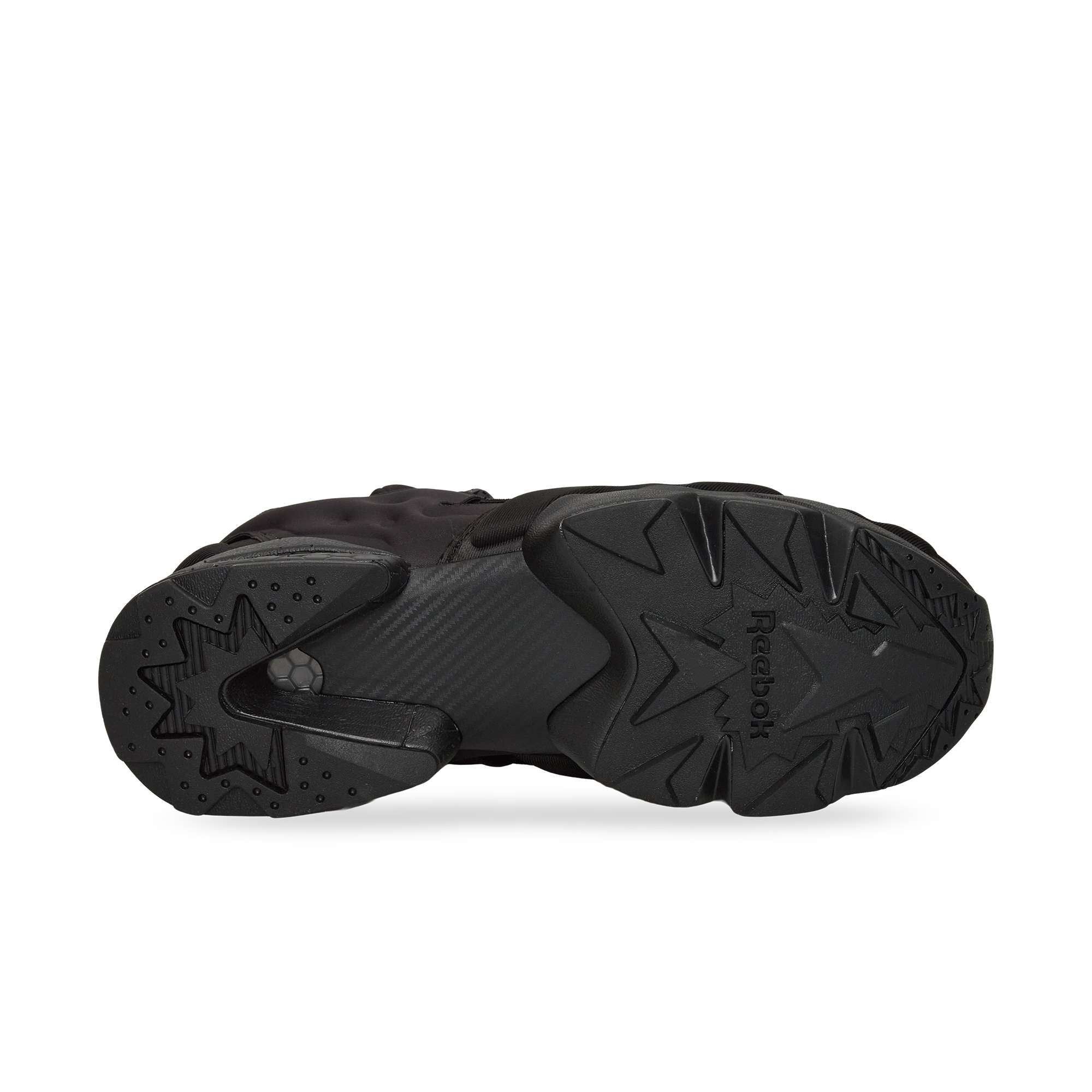The image displays the black rubber outsole of a Reebok Instapump Sliver sneaker from below, featuring textured geometric patterns and the Reebok logo designed to enhance grip and traction.