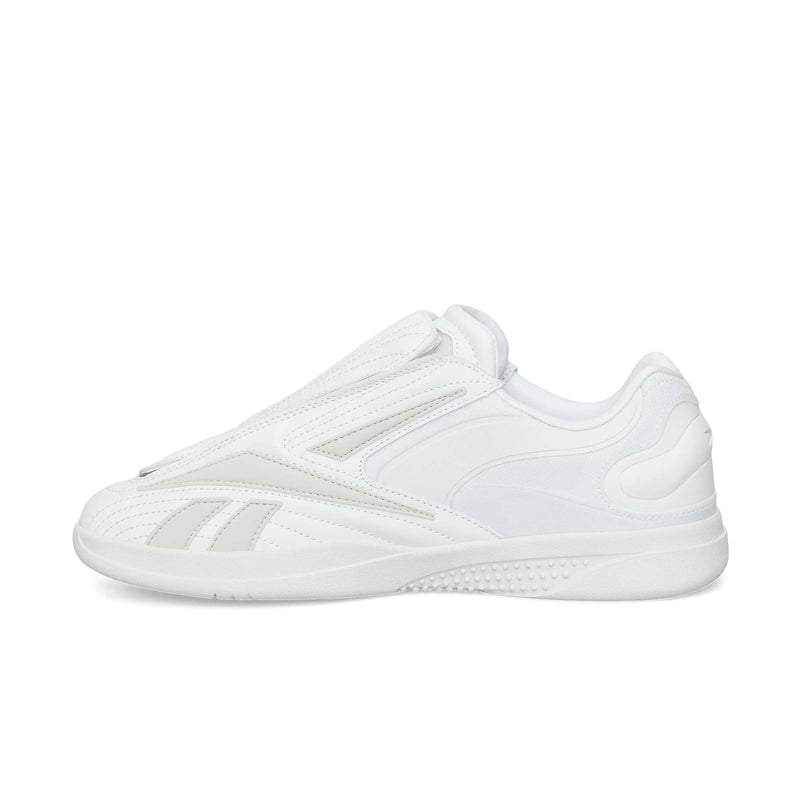 The Reebok Hammer Pro Ltd is a white low-top sneaker with a minimalist design, subtle stitching, durable rubber sole, and sleek lace-free suede upper for a modern look.