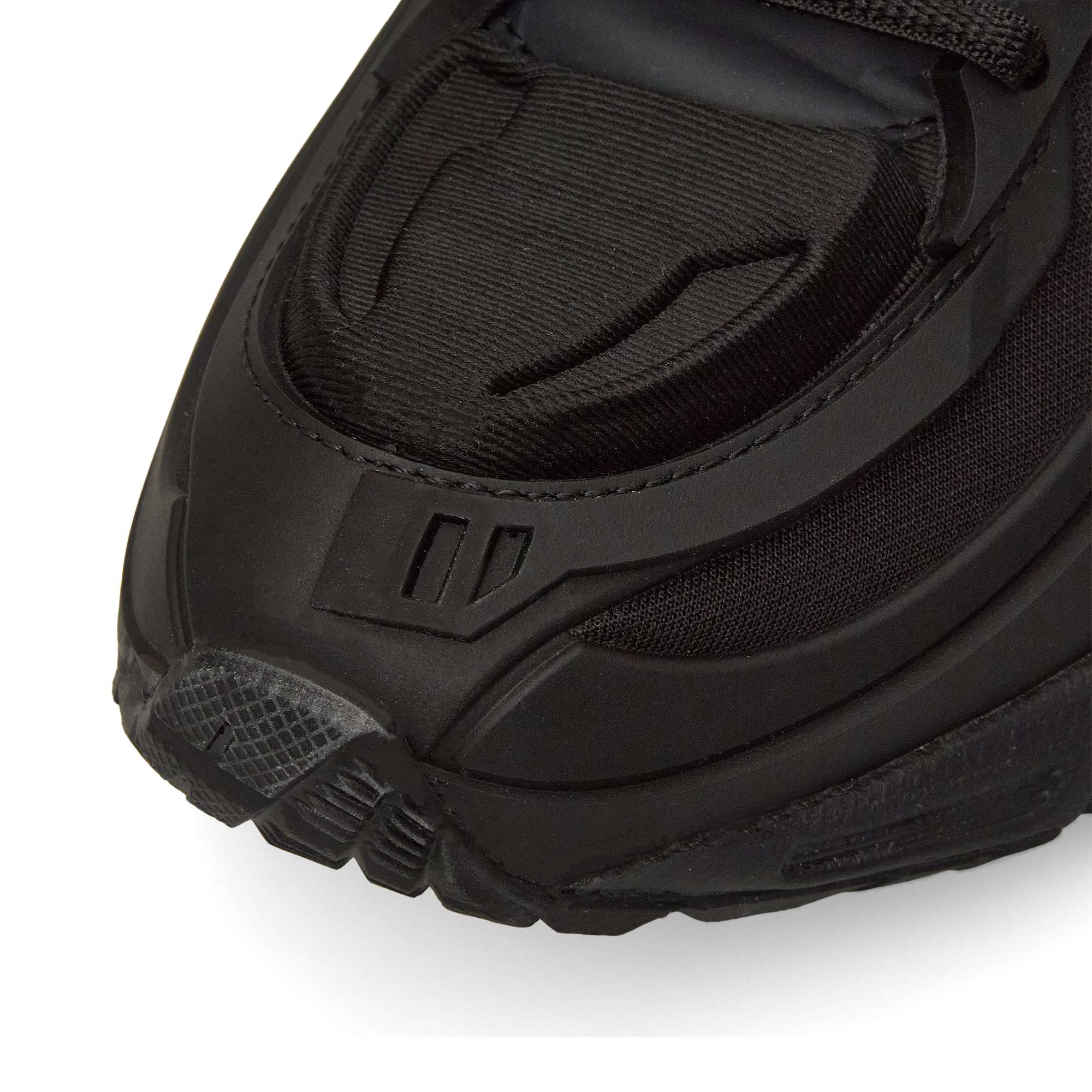 Close-up of the front of the Reebok Premier Road Modern, highlighting textured details, layered materials, and stitching on the toe and sides of this sleek black running shoe.
