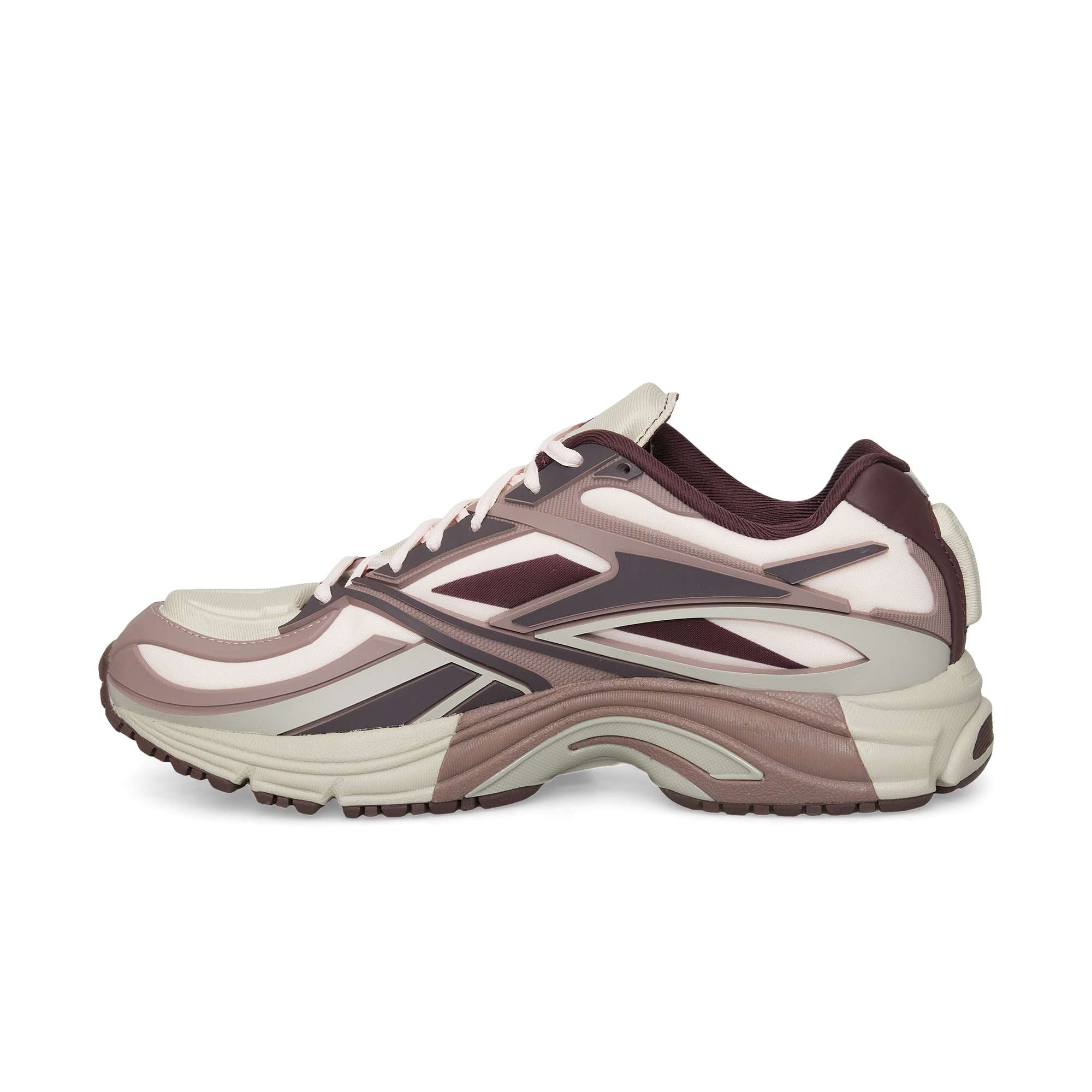 The Reebok Premier Road Modern is a stylish sneaker in cream, mauve, and dark purple, featuring layered details, a wavy sole with dual-density midsole, shown from the side on a white background.