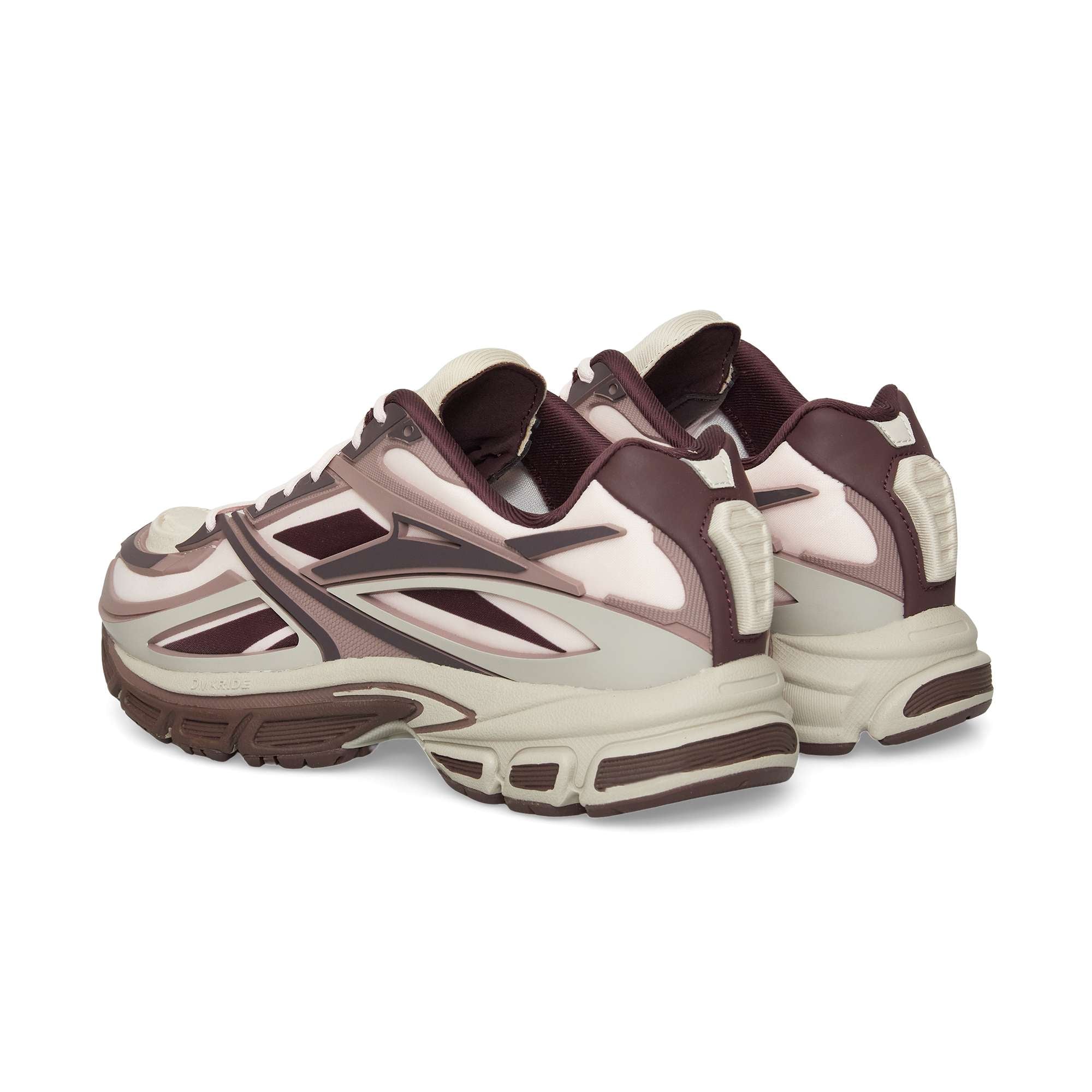 The Reebok Premier Road Modern sneakers feature a maroon, cream, and beige colorway with chunky soles and layered panels, shown from the back and side angles, inspired by archival running shoe design.