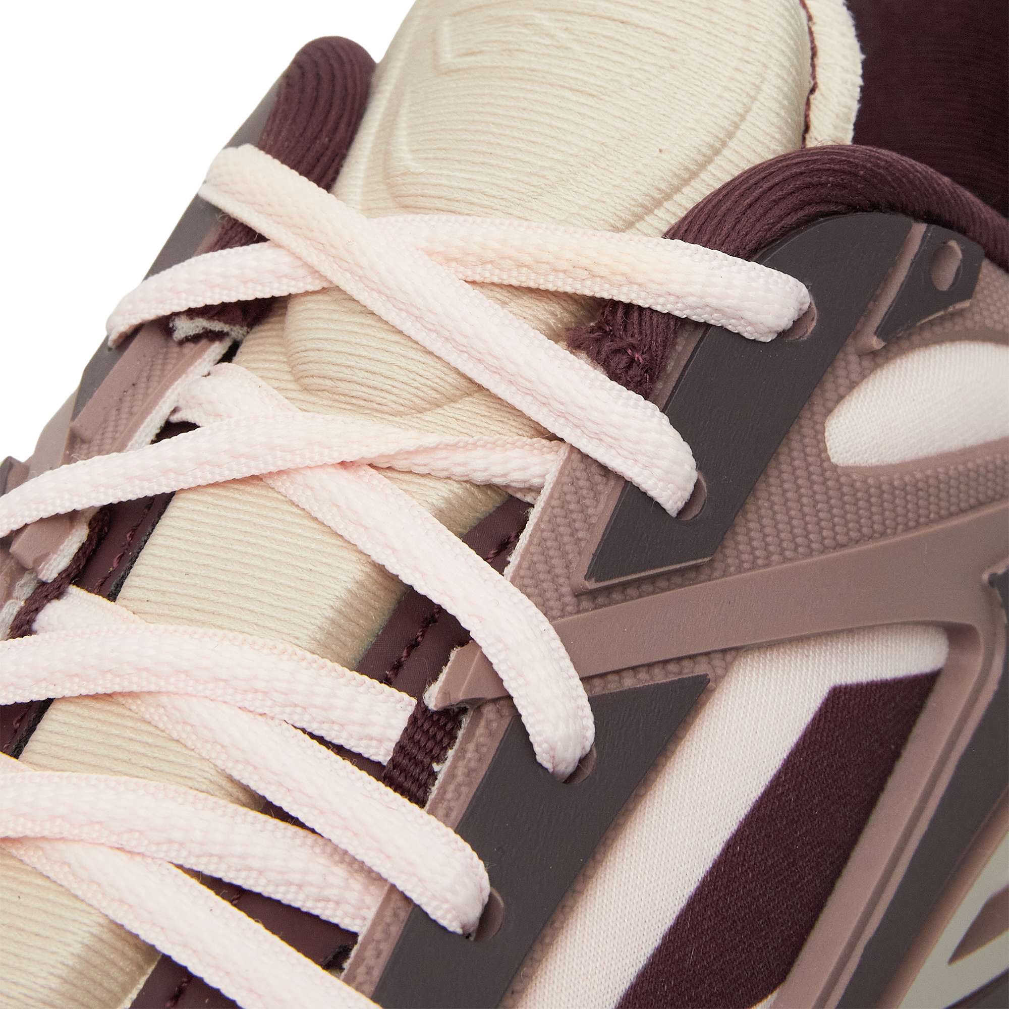 Close-up of the Reebok Premier Road Modern sneaker featuring cream laces, a beige tongue, maroon and brown overlays with textured materials, geometric accents, and a dual-density midsole inspired by classic Reebok running shoes.