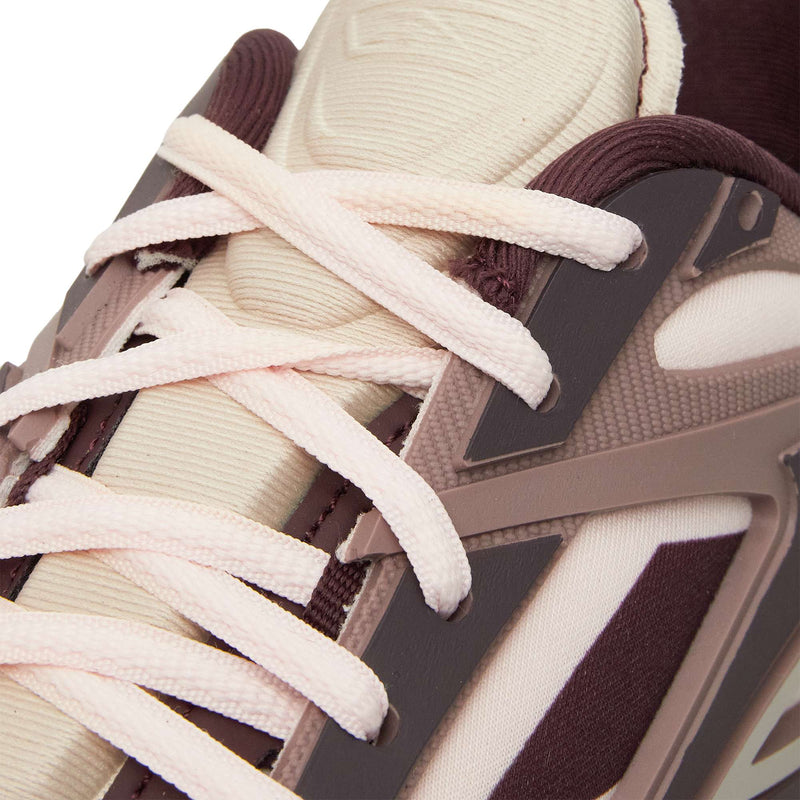 Close-up of the Reebok Premier Road Modern sneaker featuring cream laces, a beige tongue, maroon and brown overlays with textured materials, geometric accents, and a dual-density midsole inspired by classic Reebok running shoes.