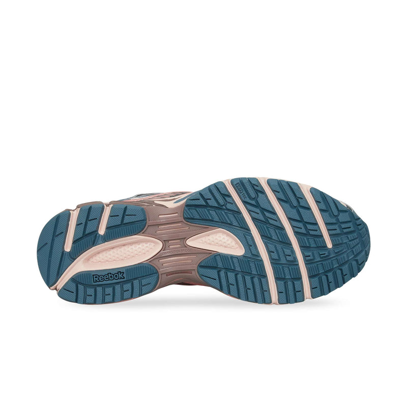The image displays the Reebok Premier Road Ultra’s sole with a teal and beige textured tread for grip, a dual-density midsole, and a visible Reebok logo on the left side.