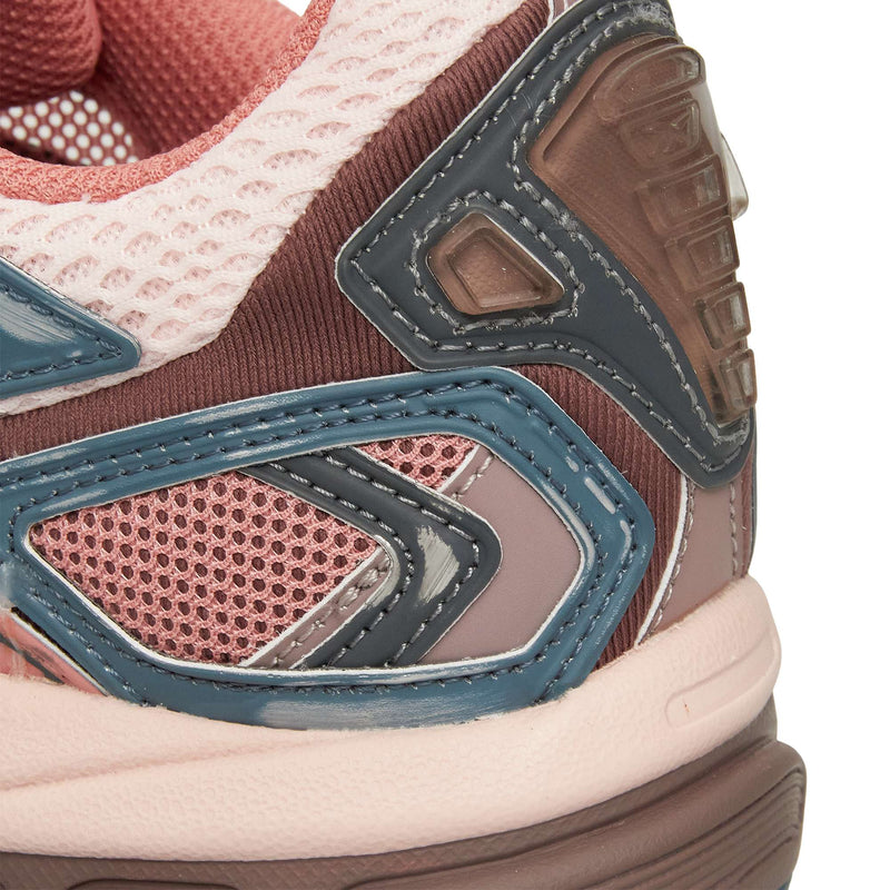 Close-up of the Reebok Premier Road Ultra heel and side, showcasing pink mesh, light pink and brown accents, blue and black details, and a dual-density midsole inspired by an archival running silhouette. Sporty layered design.