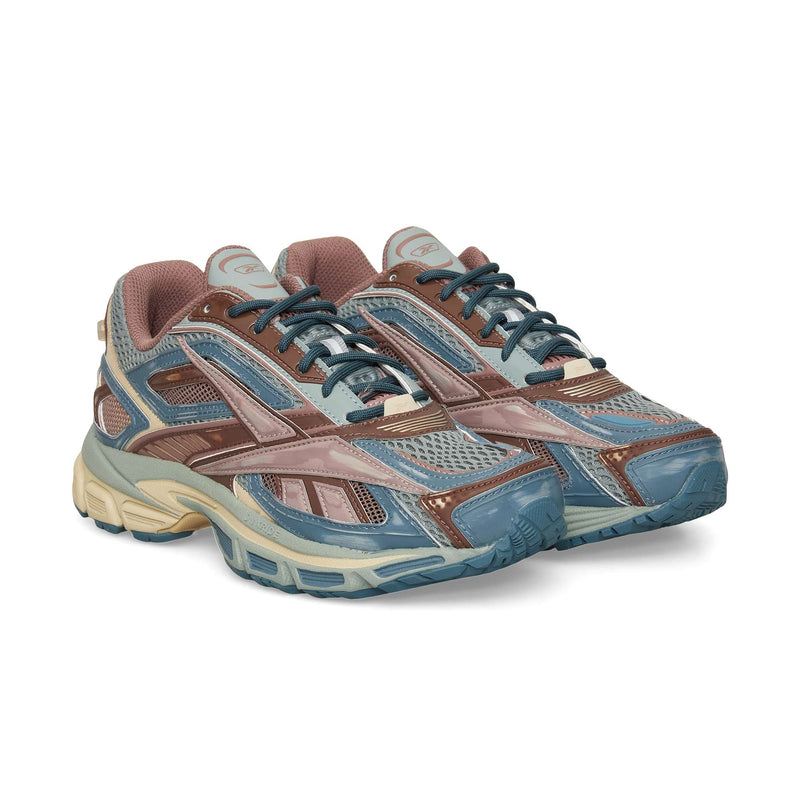 The Reebok Premier Road Ultra sneakers feature a multicolor design in blue, brown, and beige with mesh and synthetic panels, dual-density midsole for comfort, thick soles, and lace-up closures.