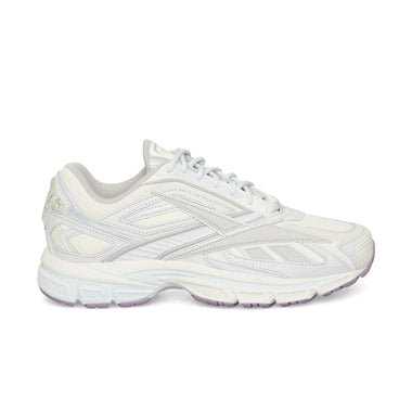 The Reebok Premier Road Ultra is a white running sneaker with light gray and silver accents, mesh and synthetic overlays, a dual-density midsole for comfort, and light purple on the outsole, shown here in side profile.