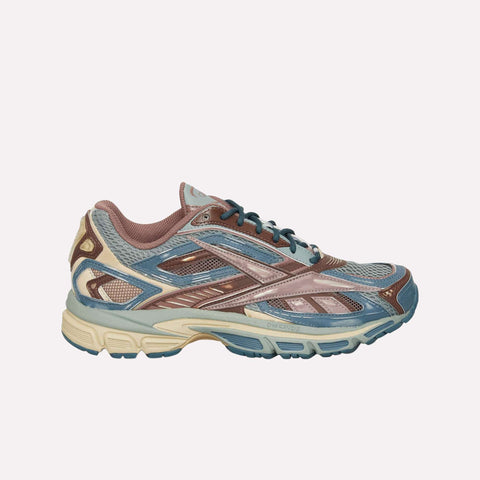 The Reebok Premier Road Ultra LTD Shoes are multicolored running sneakers in blue, brown, and beige tones with mesh and synthetic overlays, displayed in a side profile against a plain light background. Inspired by the classic Premier Road Ultra archive model, these shoes feature a supportive dual-density midsole that provides enhanced comfort and stability.