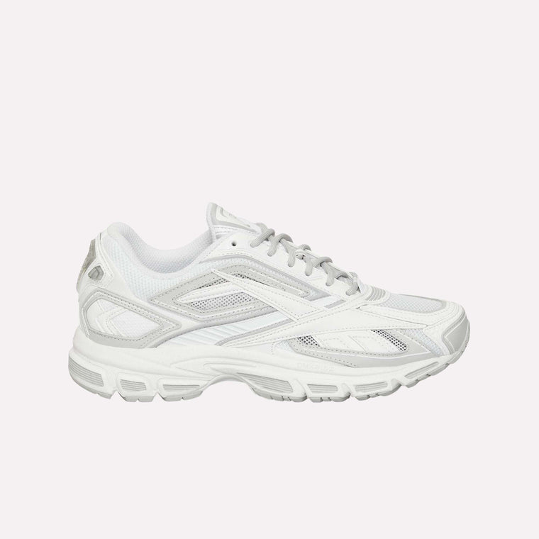 The Reebok Premier Road Ultra LTD Shoes are displayed in a side view against a plain white background. This white athletic running sneaker features gray accents, mesh panels, and a dual-density midsole. Inspired by the original Reebok Premier Road Ultra, the design includes a textured rubber sole for enhanced traction and comfort.