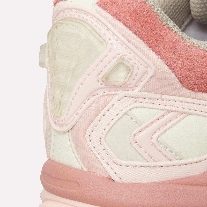 Close-up of the Reebok Premier Road Ultra sneaker's back and side in light pink, white, and beige, highlighting textured suede, smooth synthetics, detailed stitching, and a dual-density supportive midsole.