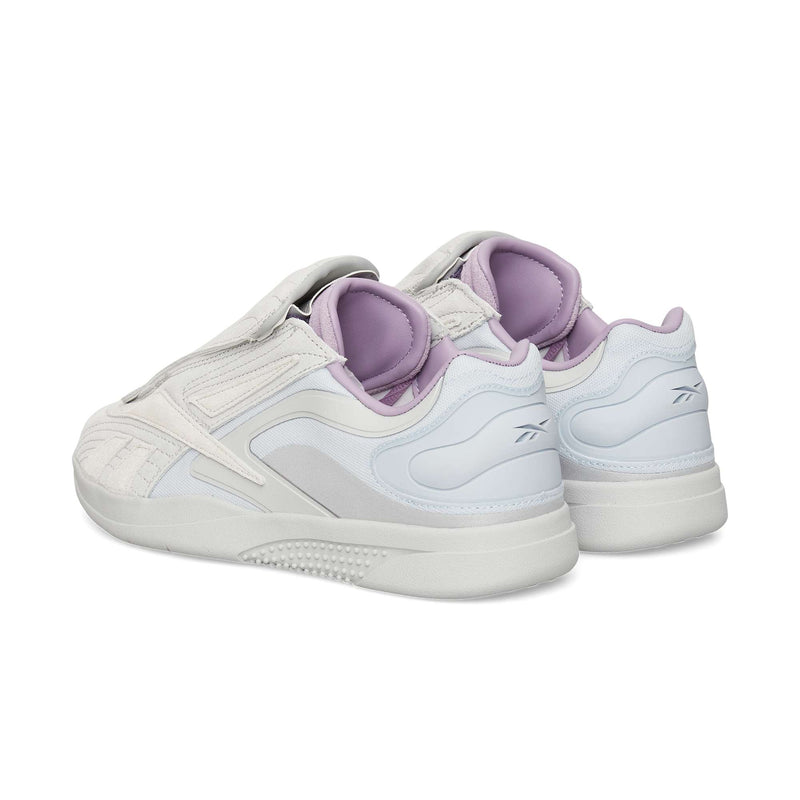 The Reebok Hammer Pro Ltd sneakers, featuring a suede upper and light purple accents on the lining and heel, are displayed from a rear side angle against a plain white background.