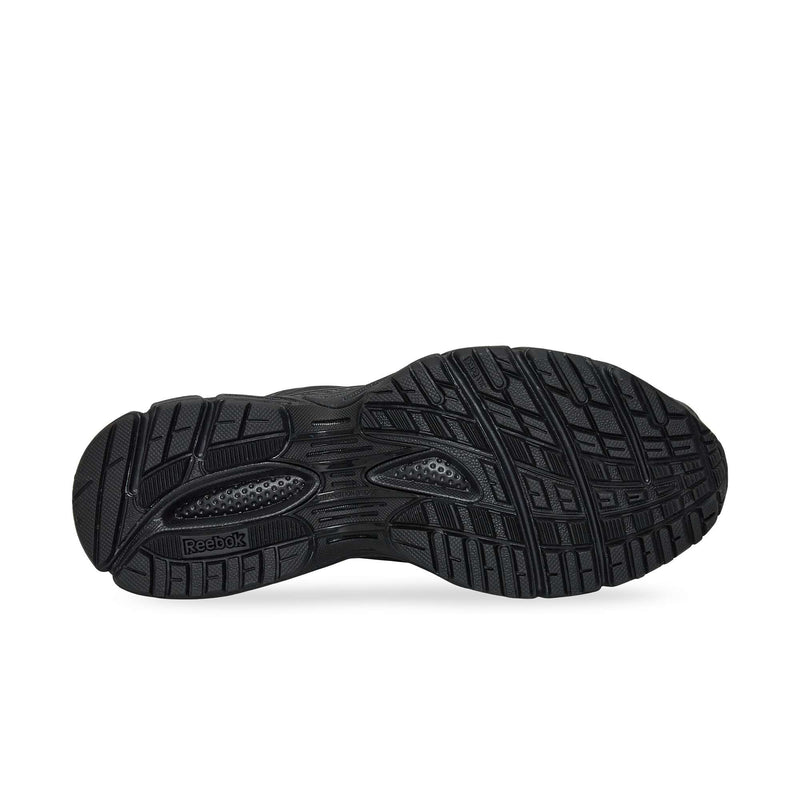 The black rubber outsole of the Reebok Premier Road Ultra running sneaker features a detailed tread pattern with grooves and textures for traction, plus a visible Reebok logo near the heel.