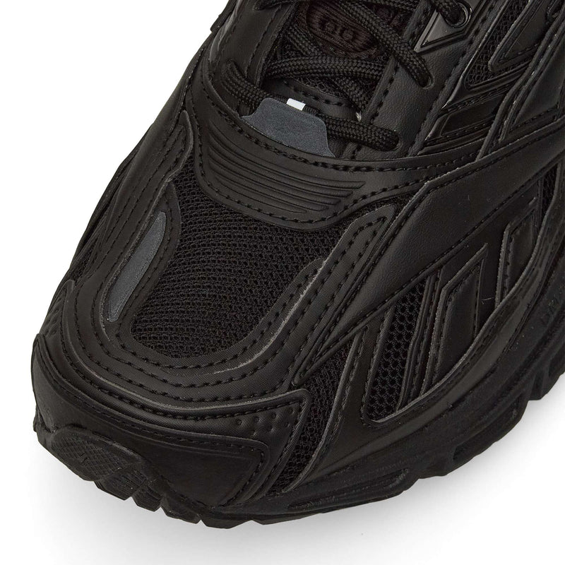 Close-up of the front and side of the Reebok Premier Road Ultra in black, highlighting detailed stitching, mesh upper, textured rubber sole, and dual-density midsole.