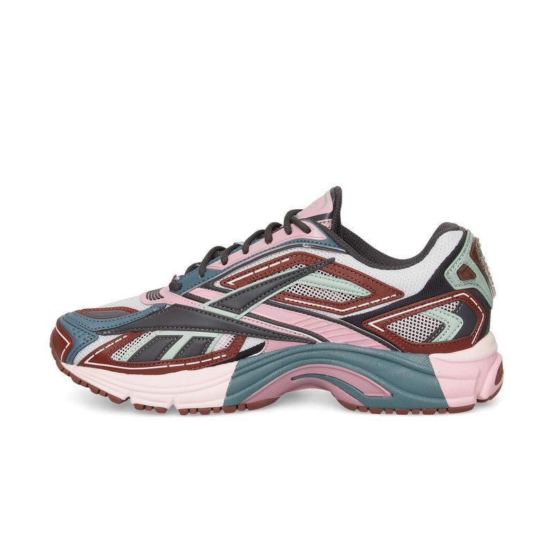 The Reebok Premier Road Ultra is a stylish sneaker with mesh and synthetic overlays, a chunky sole, and modern sporty design in pink, teal, brown, white, and black—drawing inspiration from archival running sneakers.