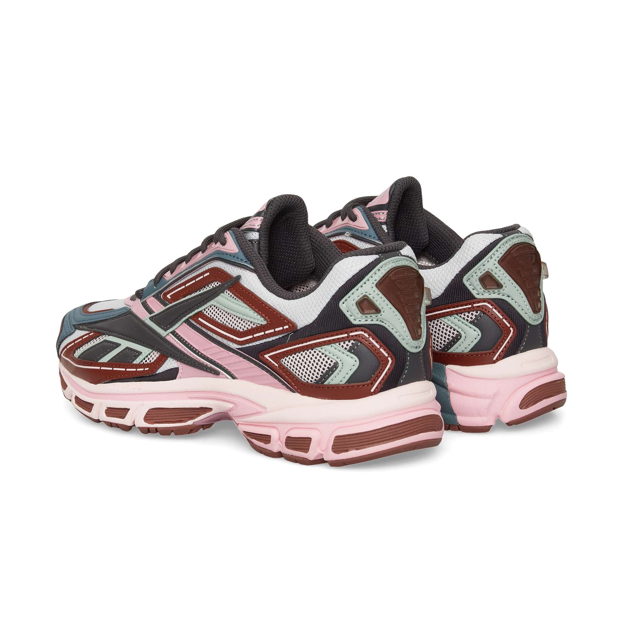 The Reebok Premier Road Ultra sneakers, shown from back and side angles, feature a blend of pink, burgundy, gray, and white with mesh and synthetic materials inspired by archival running designs.