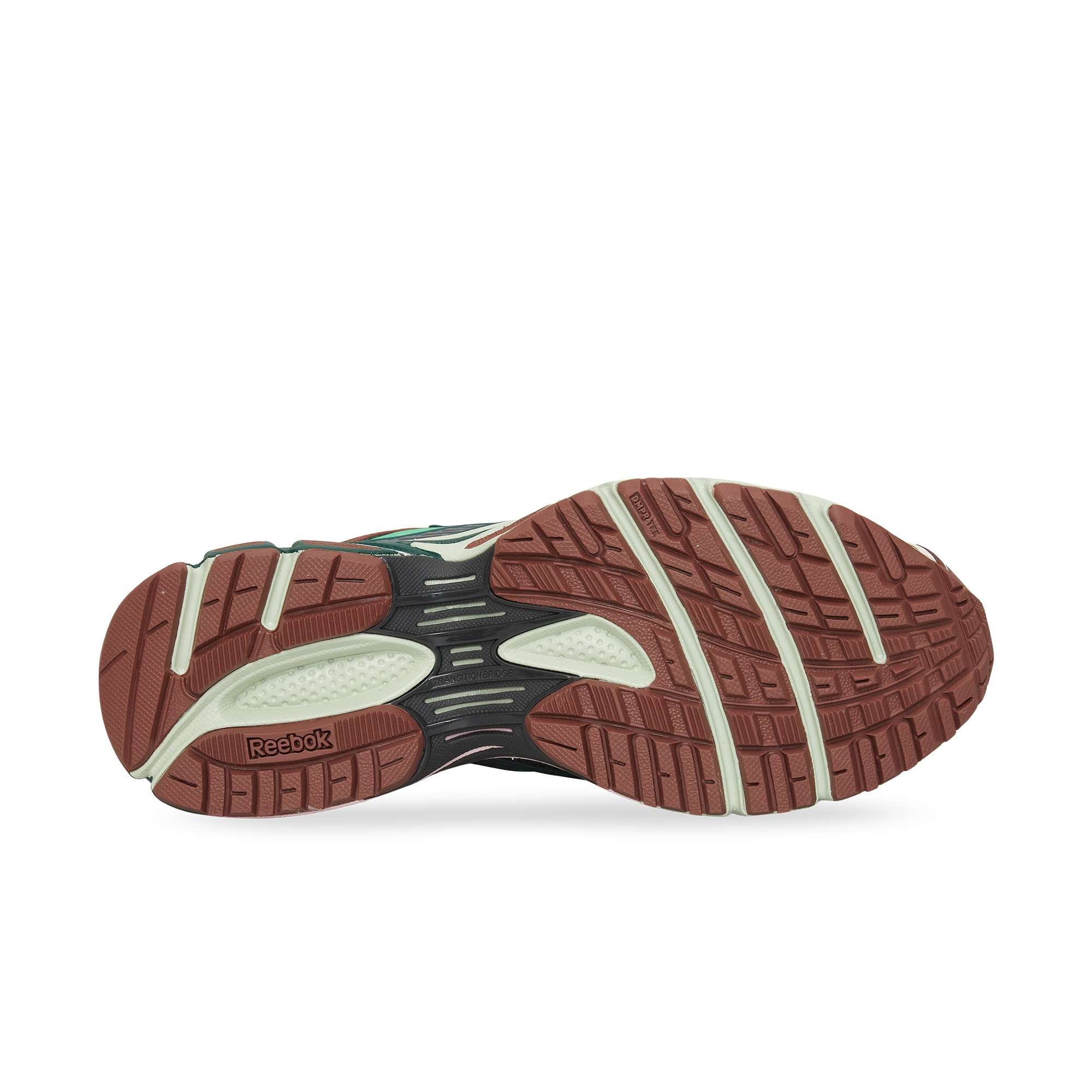 The image displays the sole of the Reebok Premier Road Ultra sneaker, featuring a brown and off-white traction pattern with visible Reebok branding and textured grooves for enhanced grip.