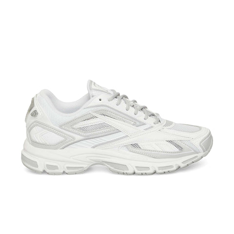 The Reebok Premier Road Ultra is a white athletic sneaker with light gray accents, mesh upper, supportive overlays, dual-density midsole, and textured rubber sole—an archival running model shown in side view on a plain white background.