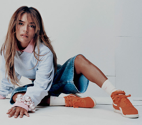 karol g wearing orange sneakers