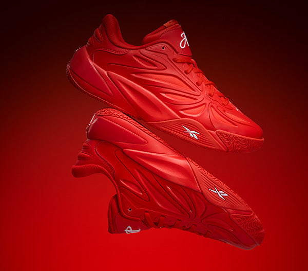 Red basketball shoes with a brand logo on a red background